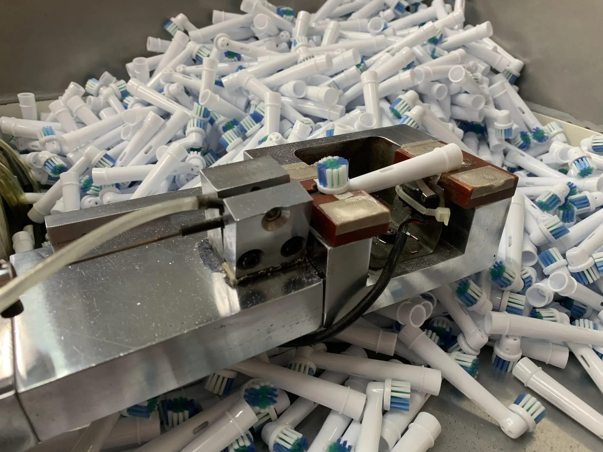 Replacement brush head components and production fixture at the AileCare facility