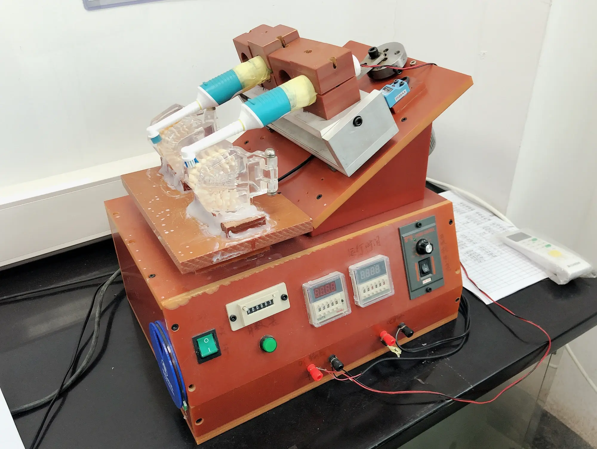 Wear and brushing test fixture running electric toothbrush samples at AileCare
