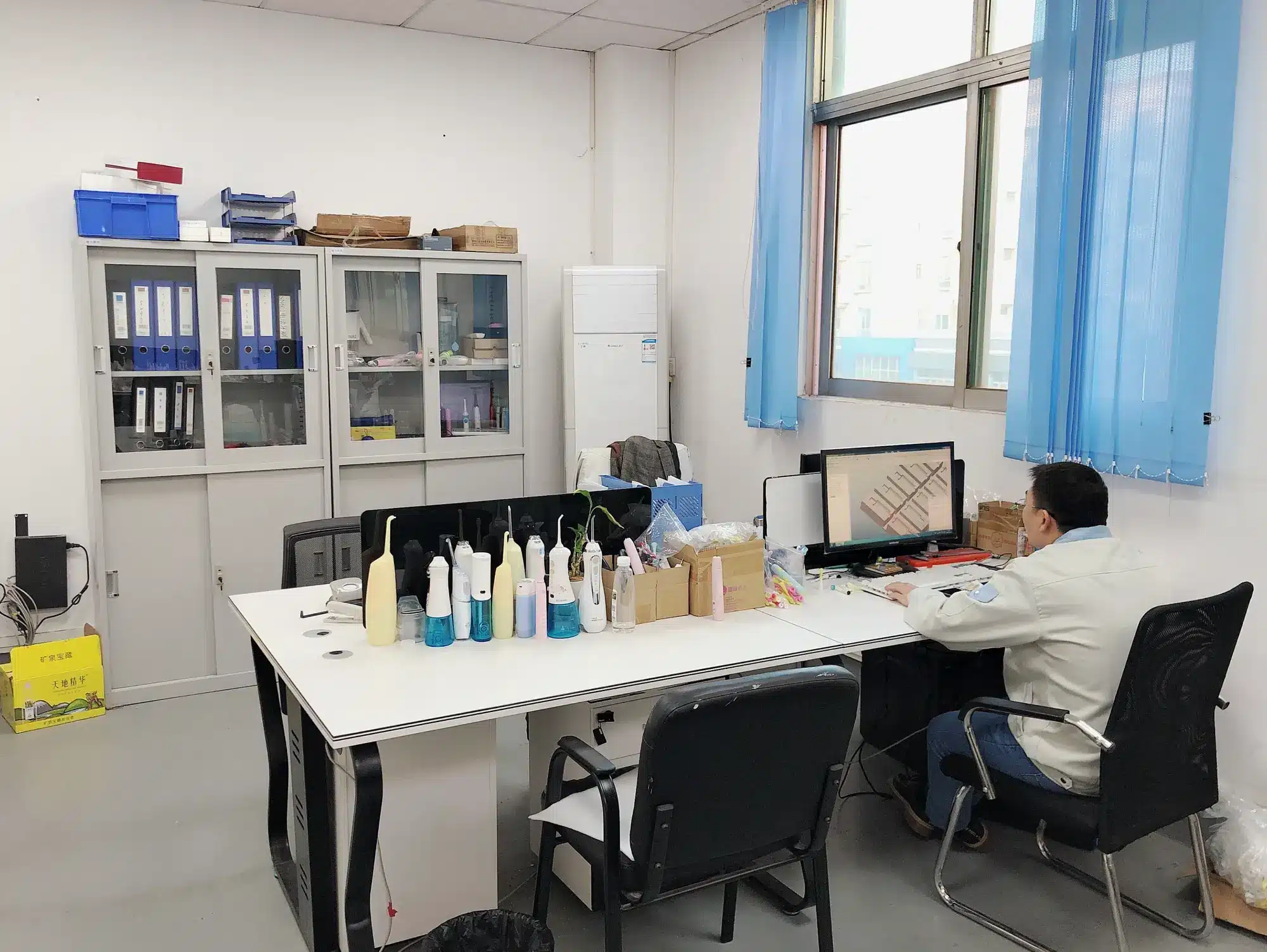 Oral care engineering workspace with CAD design and product samples