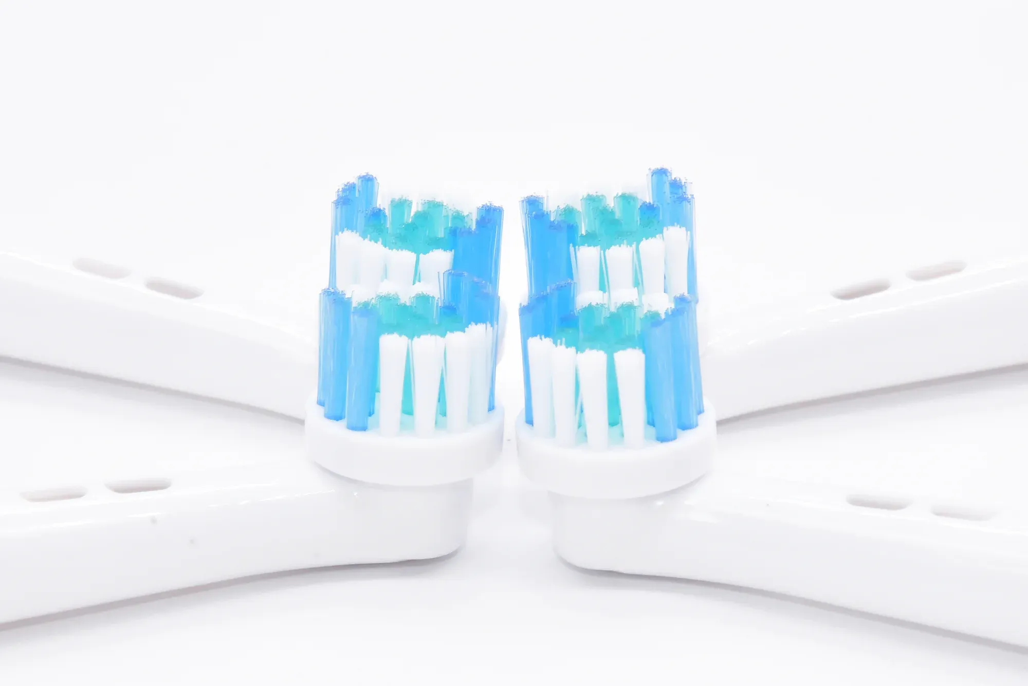 Close-up of electric toothbrush brush head bristle configuration and tuft pattern